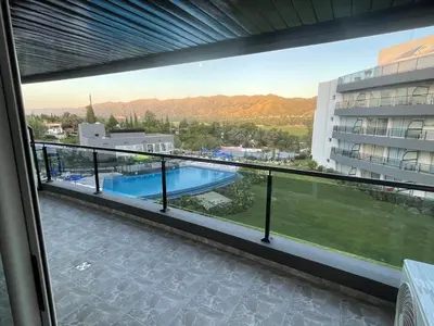 a balcony with a view of a swimming pool at Veneto Village in Villa Parque Siquiman