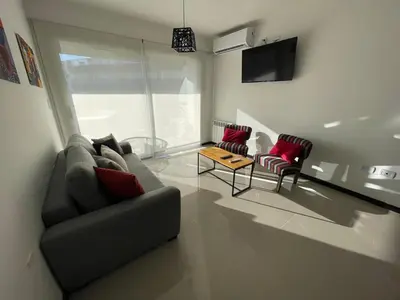 a living room with a couch and two chairs at Veneto Village in Villa Parque Siquiman