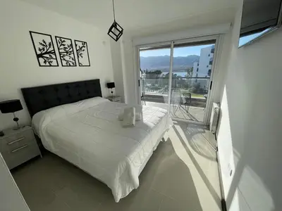 a bedroom with a bed and a large window at Veneto Village in Villa Parque Siquiman