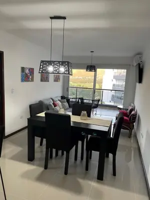 a living room with a table and chairs and a couch at Veneto Village in Villa Parque Siquiman