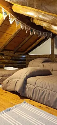 a bed sitting on the floor in a room at Sommerwind Cabañas in La Estancia