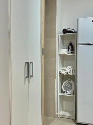 a white refrigerator in a kitchen next to a door at EXCLUSIVO LOFT CENTRICO in Alta Gracia