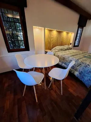 a room with a table and chairs and a bed at Loft B° Urca con cochera in Cordoba