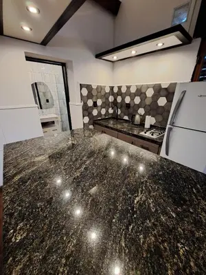 a kitchen with a large marble counter top at Loft B° Urca con cochera in Cordoba