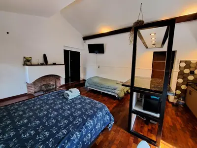 a bedroom with a bed and a mirror in it at Loft B° Urca con cochera in Cordoba