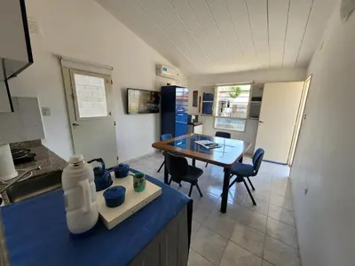 a kitchen with a blue counter top and a table at Casa en Montaña 2 habitaciones con cochera, apto mascotas in Villa Carlos Paz
