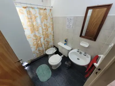 a bathroom with a toilet and a sink at Casa en Montaña 2 habitaciones con cochera, apto mascotas in Villa Carlos Paz