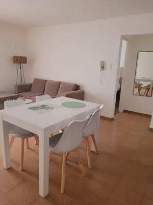 a white table and chairs in a living room at Olmos Córdoba Apart in Cordoba