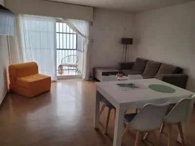 a living room with a table and a couch at Olmos Córdoba Apart in Cordoba