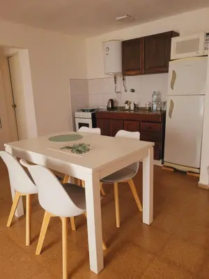 a kitchen with a white table and white chairs at Olmos Córdoba Apart in Cordoba