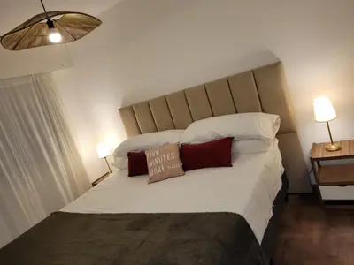 a bedroom with a large bed with two pillows at Olmos Córdoba Apart in Cordoba