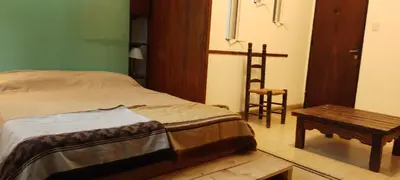 a bedroom with a bed and a table and a chair at El Estudio in Cordoba