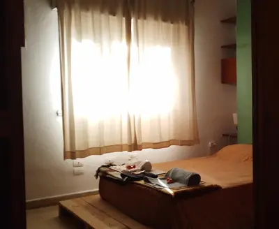 a bedroom with a bed with a large window at El Estudio in Cordoba