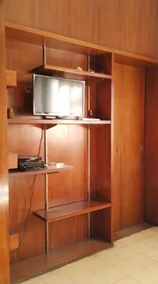 a shelf with a television on top of it at El Estudio in Cordoba
