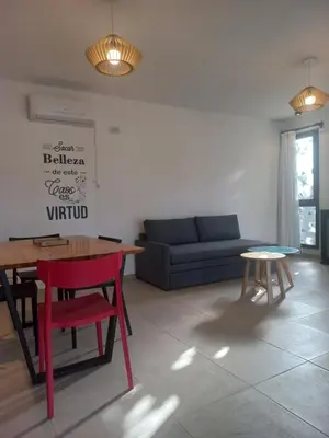 a living room with a table and a couch at TERRA CIMINTO in Villa Rumipal