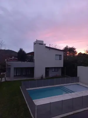 a house with a swimming pool in front of a house at TERRA CIMINTO in Villa Rumipal