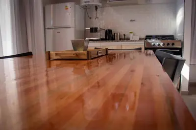 a kitchen with a wooden floor and a refrigerator at TERRA CIMINTO in Villa Rumipal