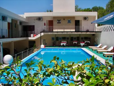 a large swimming pool in front of a building at Hosteria Aguaribay in Mina Clavero