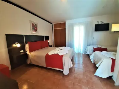 a hotel room with two beds with towels on them at Hosteria Aguaribay in Mina Clavero