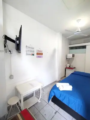 a bedroom with a blue bed and a table at Habitación para 2 personas con baño privado in Cordoba
