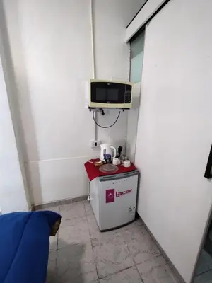 a small room with a small refrigerator and a microwave at Habitación para 2 personas con baño privado in Cordoba