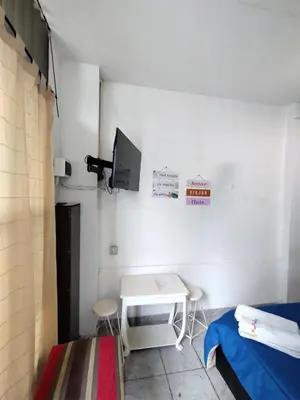 a small room with a table and a tv at Habitación para 2 personas con baño privado in Cordoba