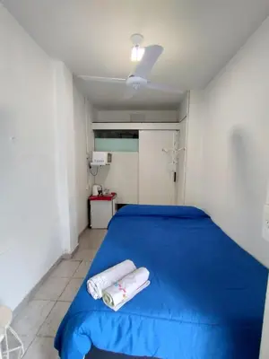 a bedroom with a blue bed with towels on it at Habitación para 2 personas con baño privado in Cordoba