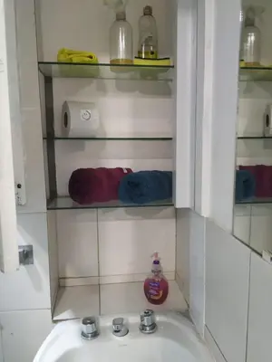 a bathroom with a sink and a shelf with towels at Habitación para 2 personas con baño privado in Cordoba