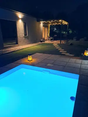 a swimming pool in a yard at night at Hada del Champaqui - Posada de Montaña in Villa General Belgrano