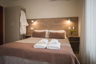 a bedroom with a bed with two towels on it at Altos del Champaqui in Villa Carlos Paz