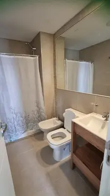 a bathroom with a toilet and a sink and a mirror at Hermoso departamento temporario en zona centro a metros de la terminal e importantes hospitales in Cordoba