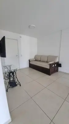 a living room with a couch and a table and a tv at Hermoso departamento temporario en zona centro a metros de la terminal e importantes hospitales in Cordoba