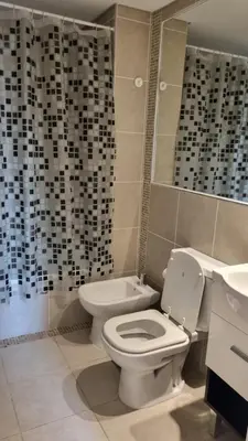 a bathroom with a toilet and a sink at Hermoso departamento temporario en zona centro a metros de la terminal e importantes hospitales in Cordoba