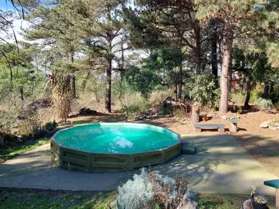 a small swimming pool in a yard with trees at Luna Plateada - Terrafirme in Villa Yacanto