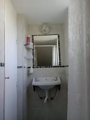 a bathroom with a sink and a mirror at Monoambiente El Sosiego in Alta Gracia