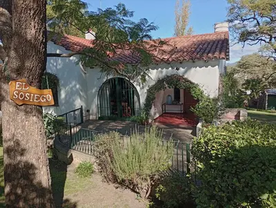 a house with a sign in front of it at Monoambiente El Sosiego in Alta Gracia