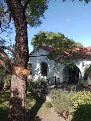 a sign on a tree in front of a house at Monoambiente El Sosiego in Alta Gracia