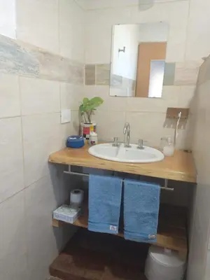a bathroom with a sink and a mirror at Abrazados Suites del Valle in Villa Yacanto