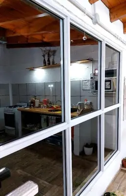 a view of a kitchen through a window at Abrazados Suites del Valle in Villa Yacanto