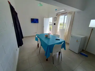 a blue table and chairs in a room at Departamentos Universidad in Río Cuarto