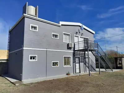 a large building with a spiral staircase next to it at Departamentos Universidad in Río Cuarto
