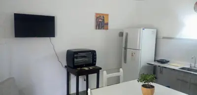 a kitchen with a small tv and a refrigerator at Alojamiento Taravella in Cordoba