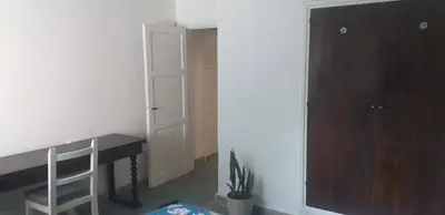 a room with a desk and a wooden cabinet at Alojamiento Taravella in Cordoba