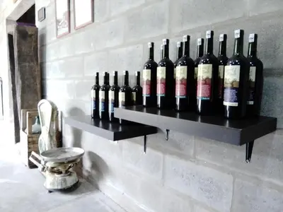a bunch of bottles of wine on a wall at Casa del viñedo in Villa de Las Rosas