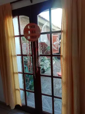 a window with a sign that reads grand bazaar sell truth at La casa de Lily in Alta Gracia