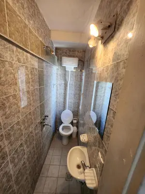 a bathroom with a toilet and a sink at Departamentos Meraki in Villa Carlos Paz