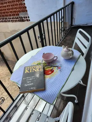a book sitting on top of a table on a balcony at Departamentos Meraki in Villa Carlos Paz