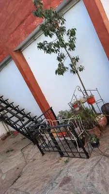 a pile of chairs sitting in front of a building at Departamentos Meraki in Villa Carlos Paz