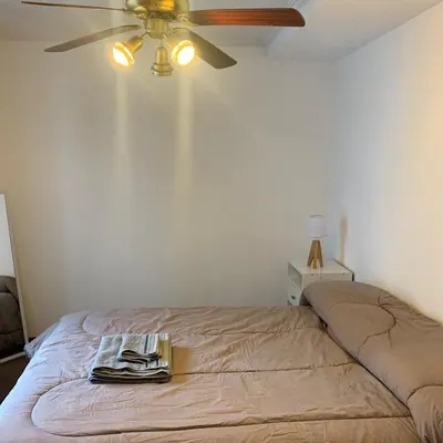 a bedroom with a bed with a ceiling fan at Hipólito Yrigoyen 150 in Cordoba