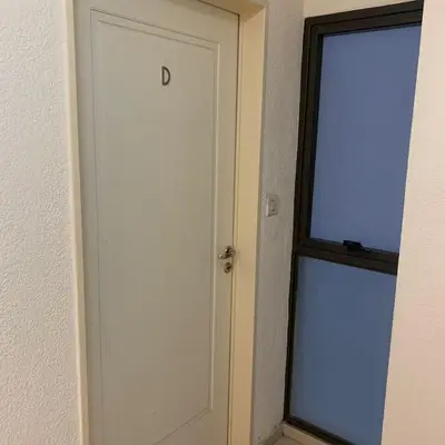 a white door with the letter d on it next to a window at Hipólito Yrigoyen 150 in Cordoba